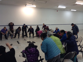 Photo 3:Salluit Elders playing with a rope and a shoe to grab bills, June 16 2014.